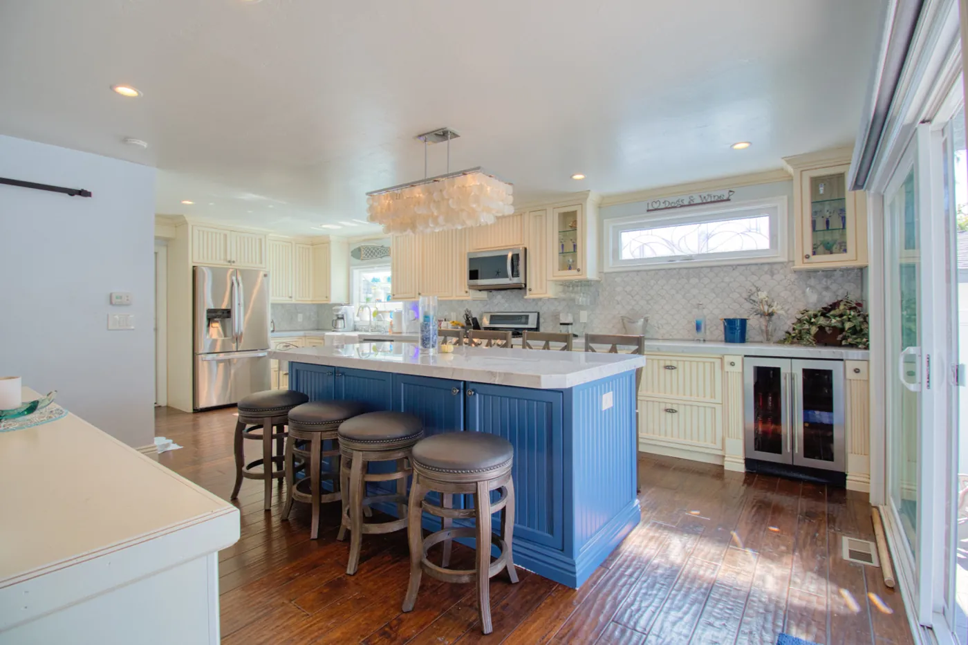 Coastal kitchen with blue island and quartz countertops