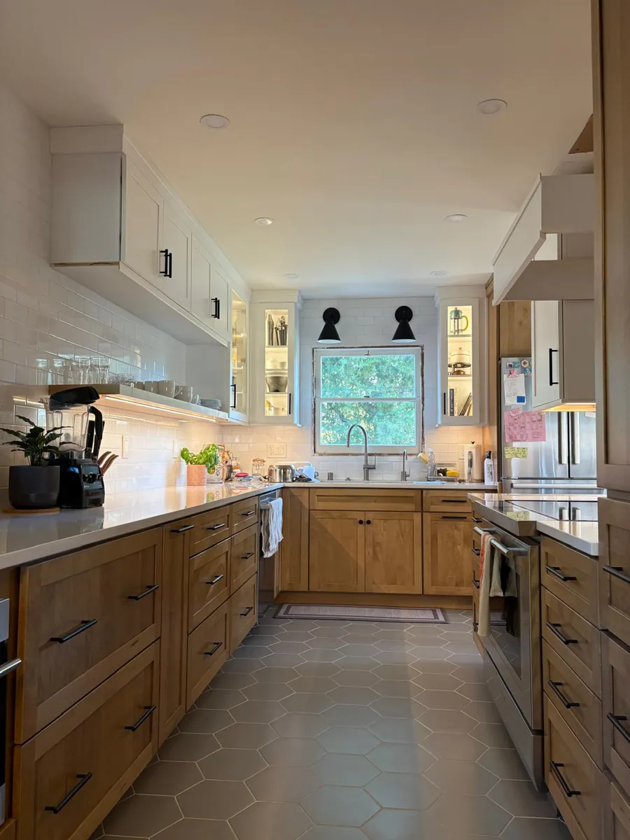 Light oak galley kitchen with white countertops