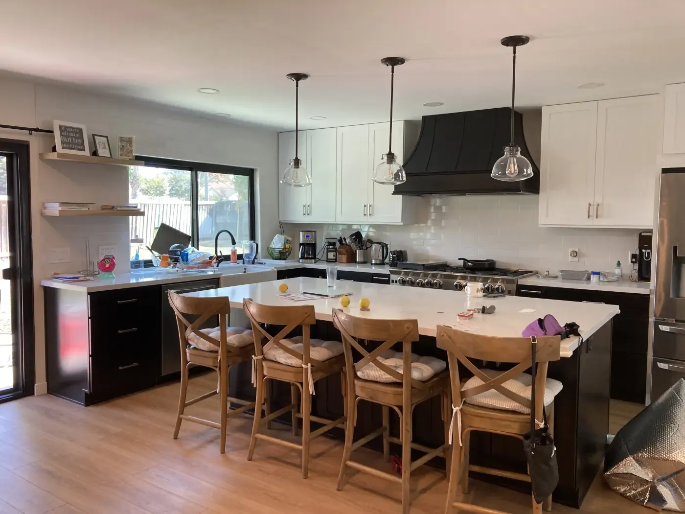 White shaker kitchen with wood island and pendant lighting