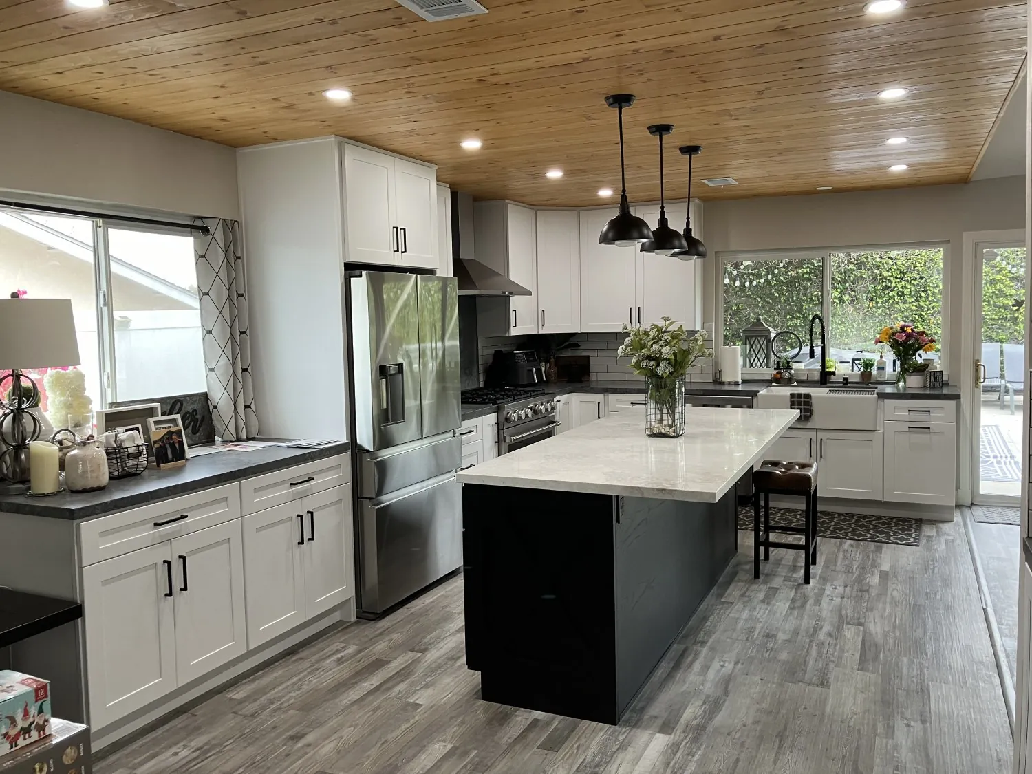 Open-plan farmhouse kitchen with island seating and pendant lights