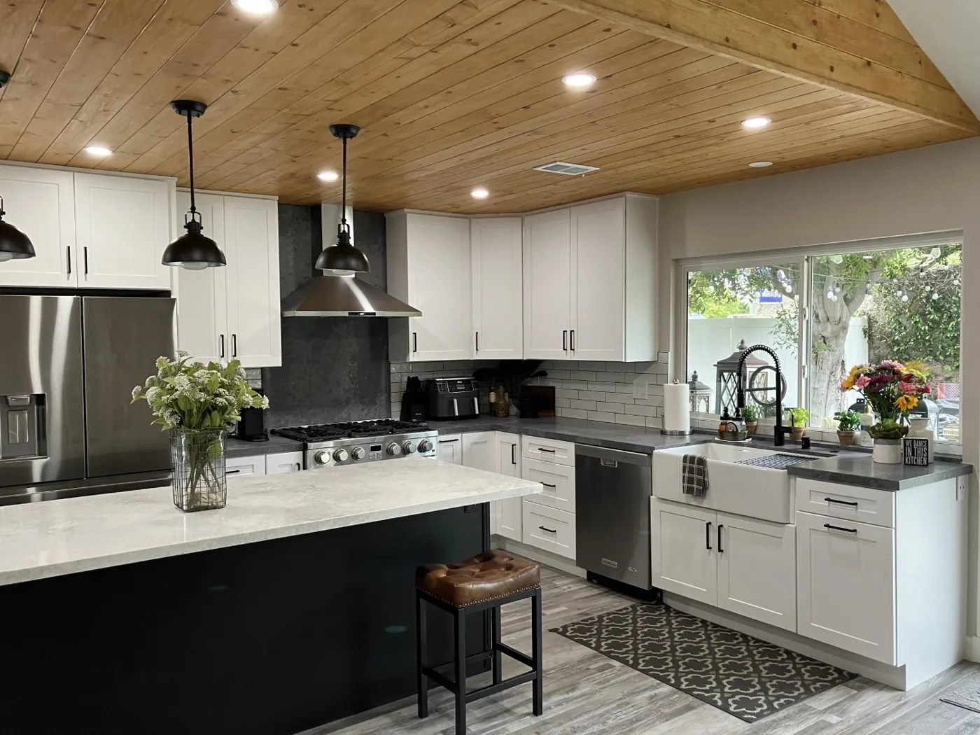 Bright farmhouse kitchen with quartz island and pendant lights